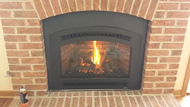 A close look at a gas insert with an arched front and the fire on, set in a red brick arch.