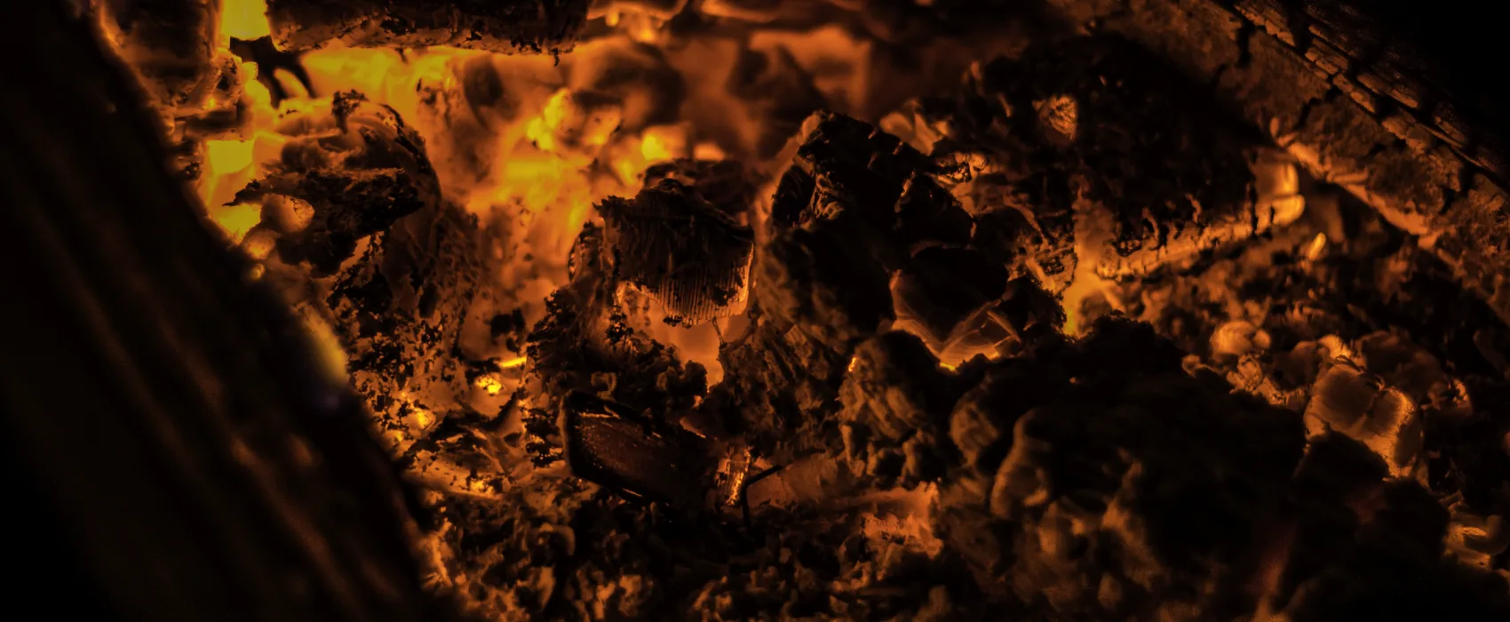 A bed of glowing coals in a firebox.