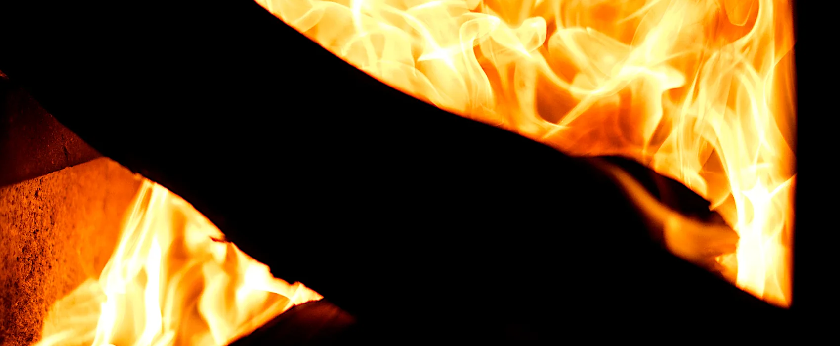 Flames rising inside a dark firebox.