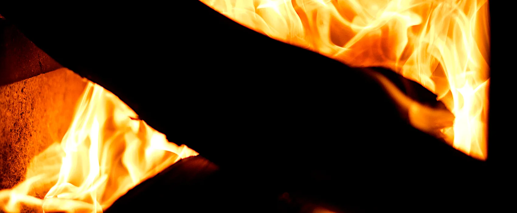 Flames rising inside a dark firebox.