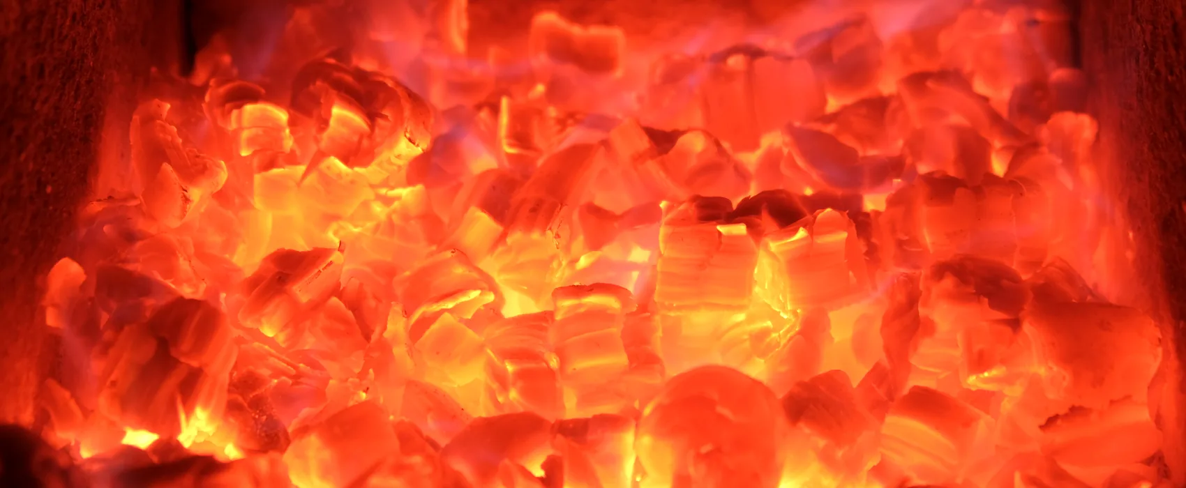 A close view of a wall of glowing embers.