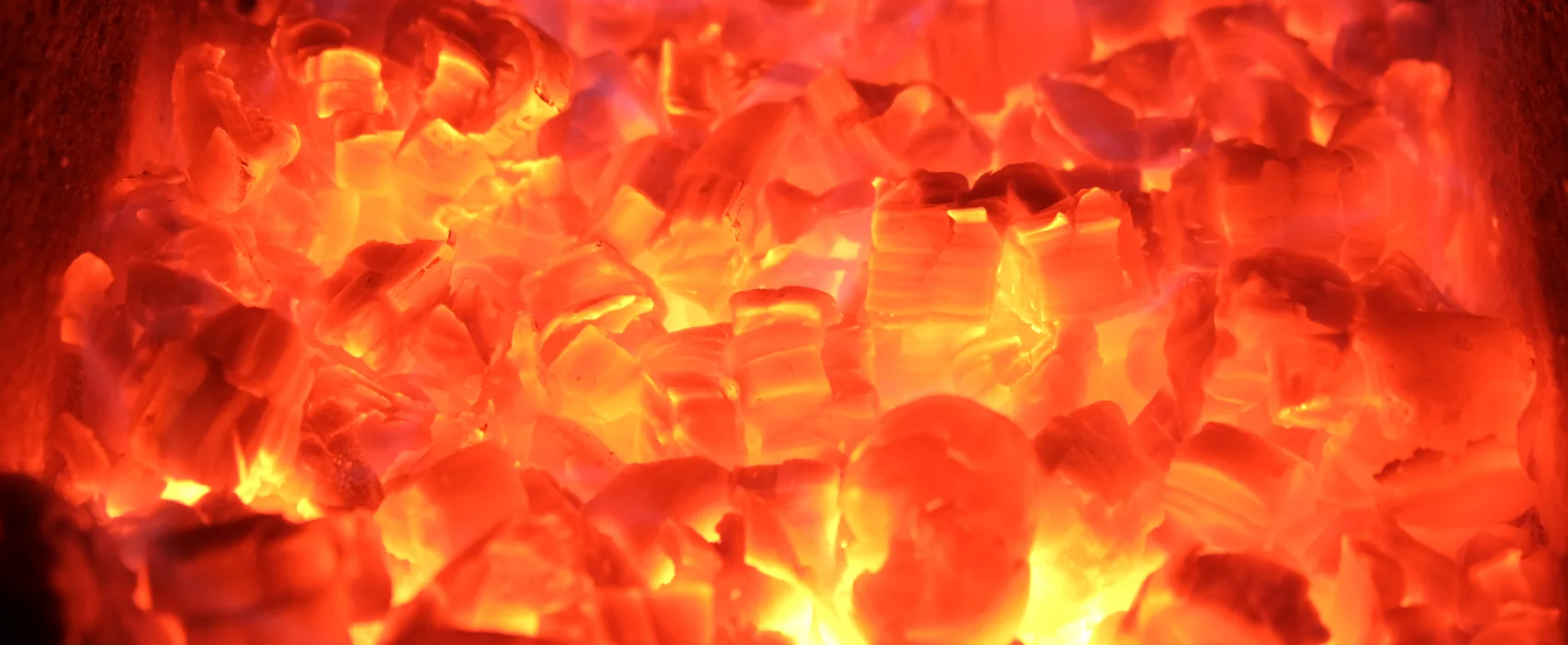 A close view of a wall of glowing embers.