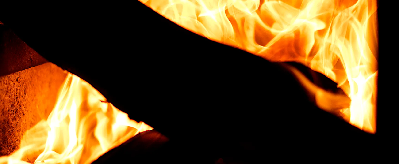 Flames rising inside a dark firebox.